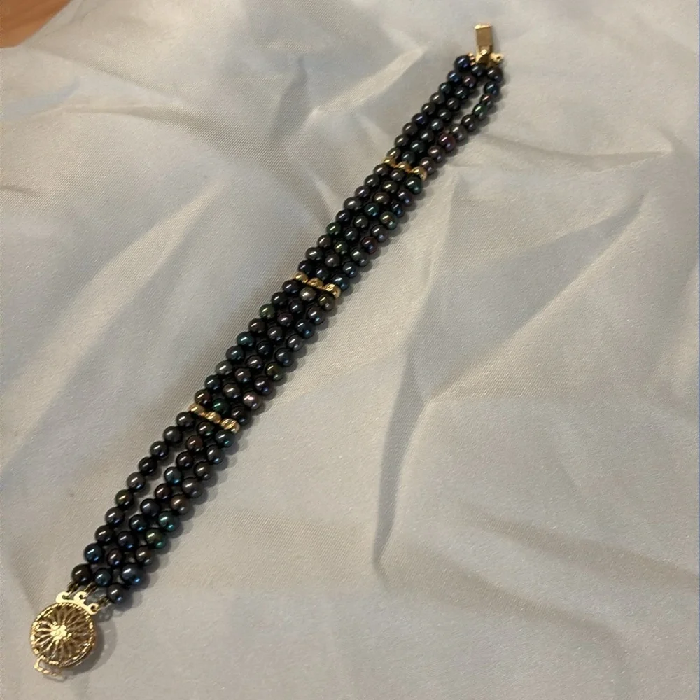 Tahitian black pearl bracelet with 14k gold filigree clasp.